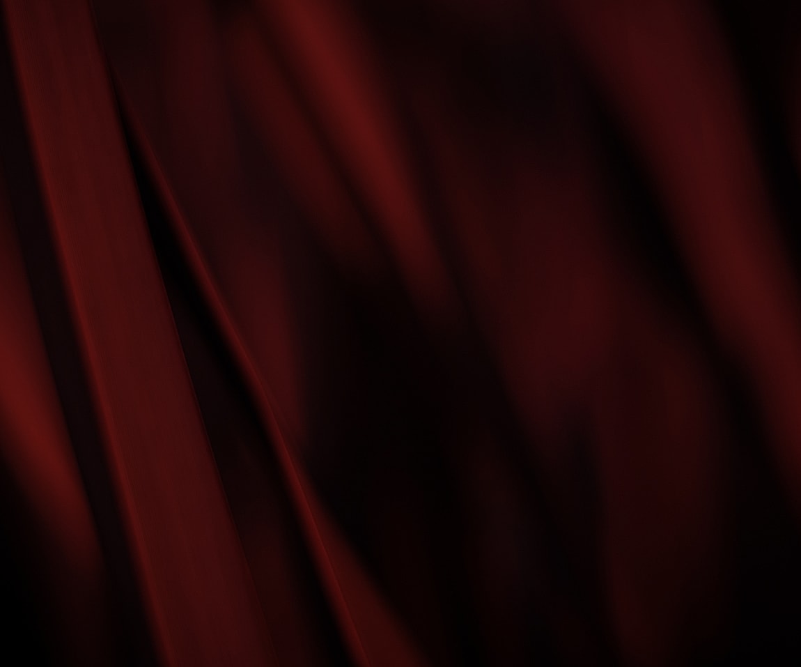 Textured red fabric in soft, flowing patterns.