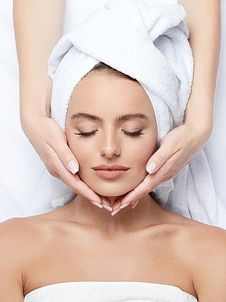 Woman receiving a relaxing facial treatment.