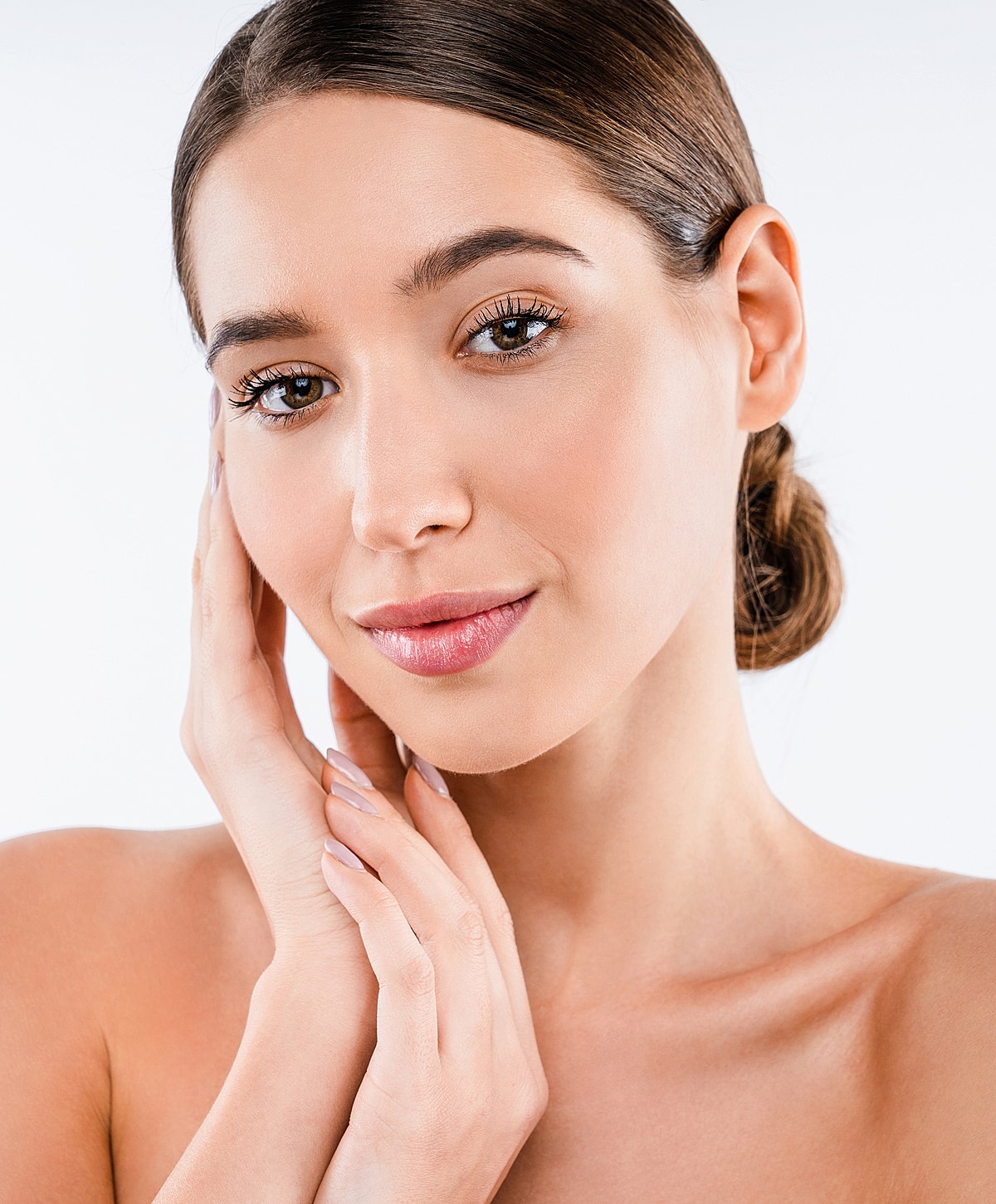 Woman with flawless skin touching her face.