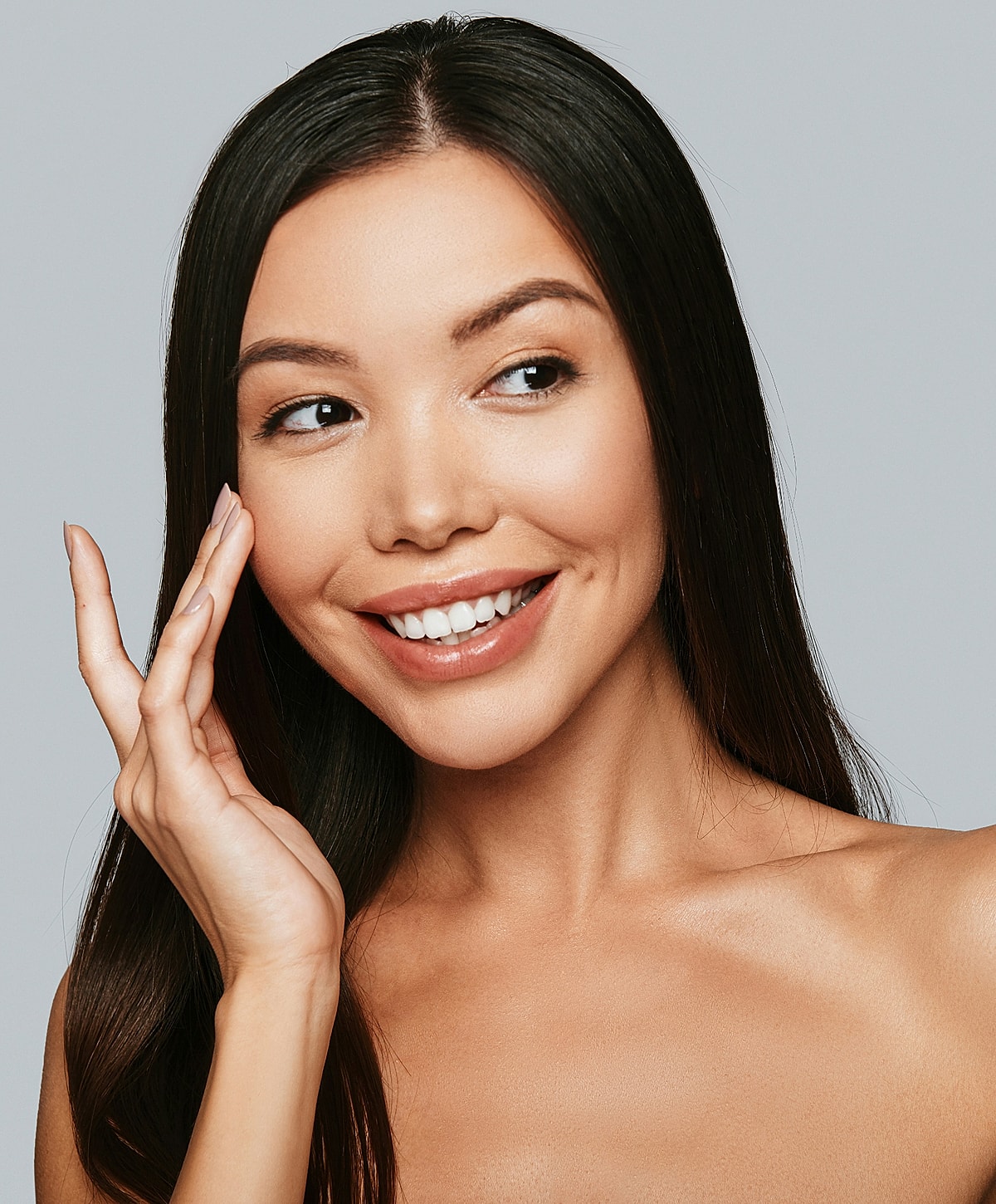 Smiling woman touching her face, natural beauty.