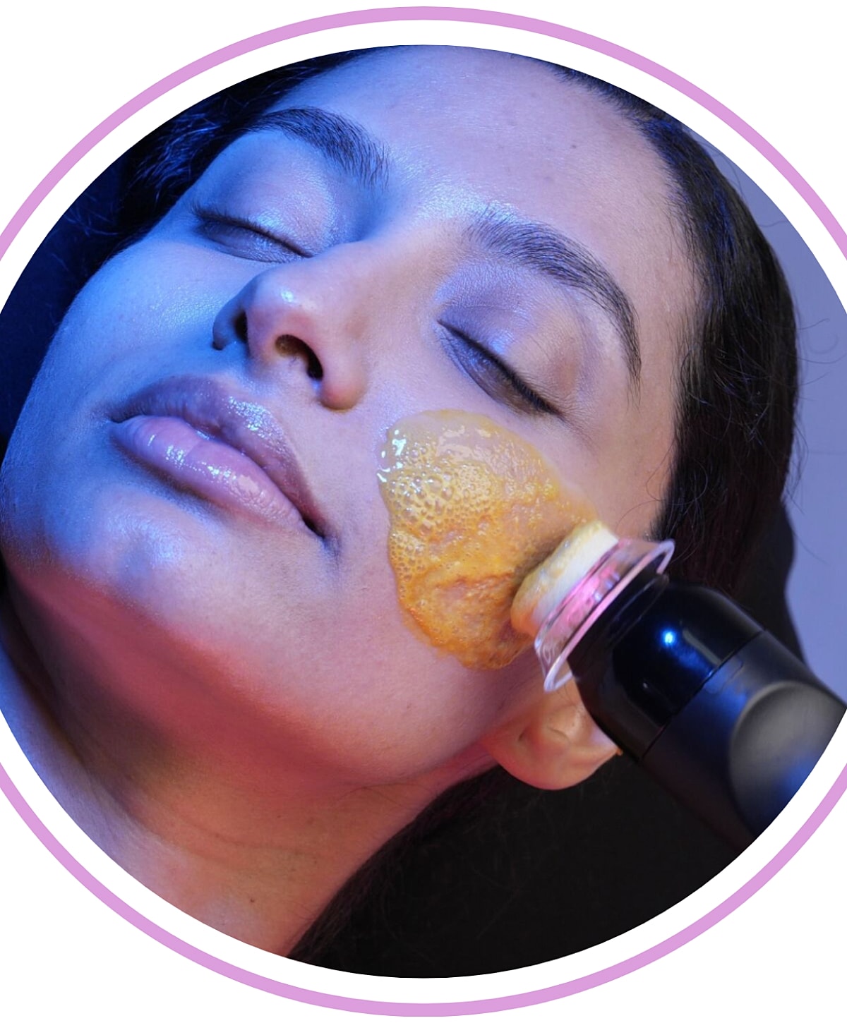 Woman enjoying a facial treatment with a device.