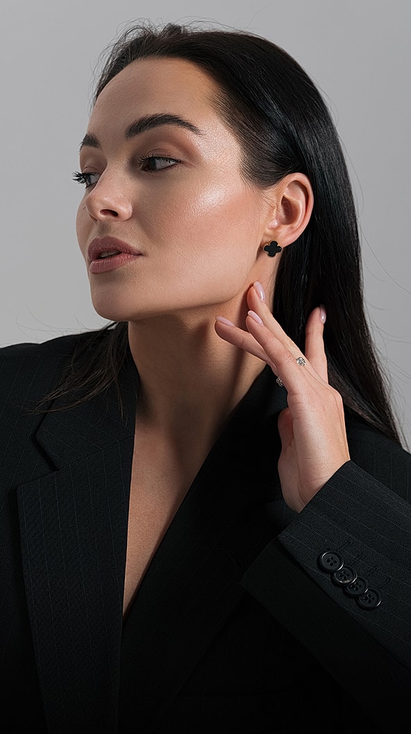 Woman wearing stylish earrings and a blazer.