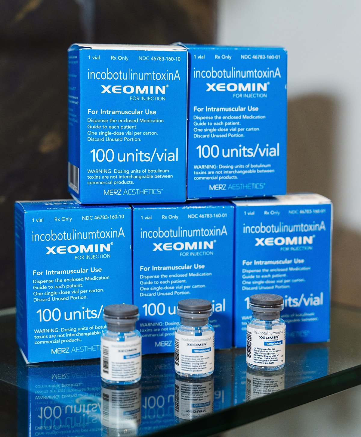 Xeomin injection vials and packaging on glass table