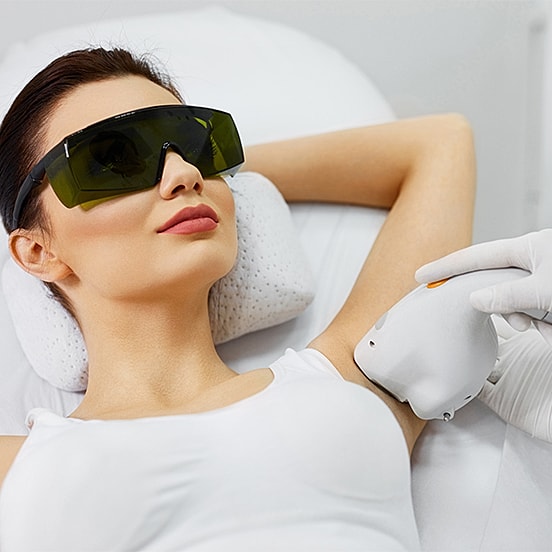 Woman receiving laser hair removal treatment.