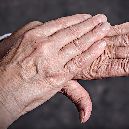 Two hands gently touching each other.