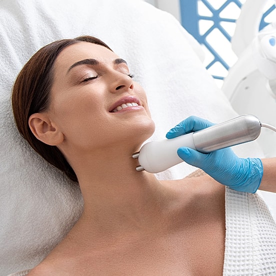 Woman receiving skincare treatment in spa setting.