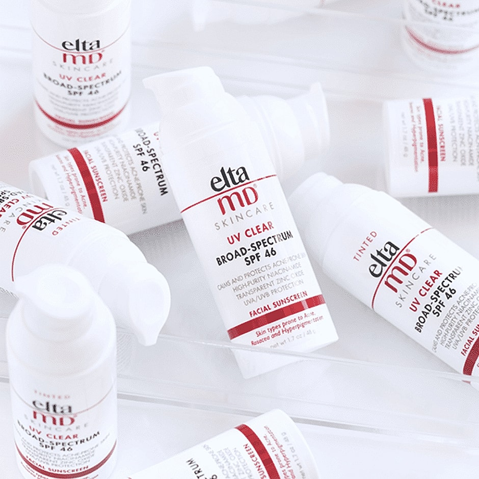 Elta MD sunscreen bottles arranged on a surface.