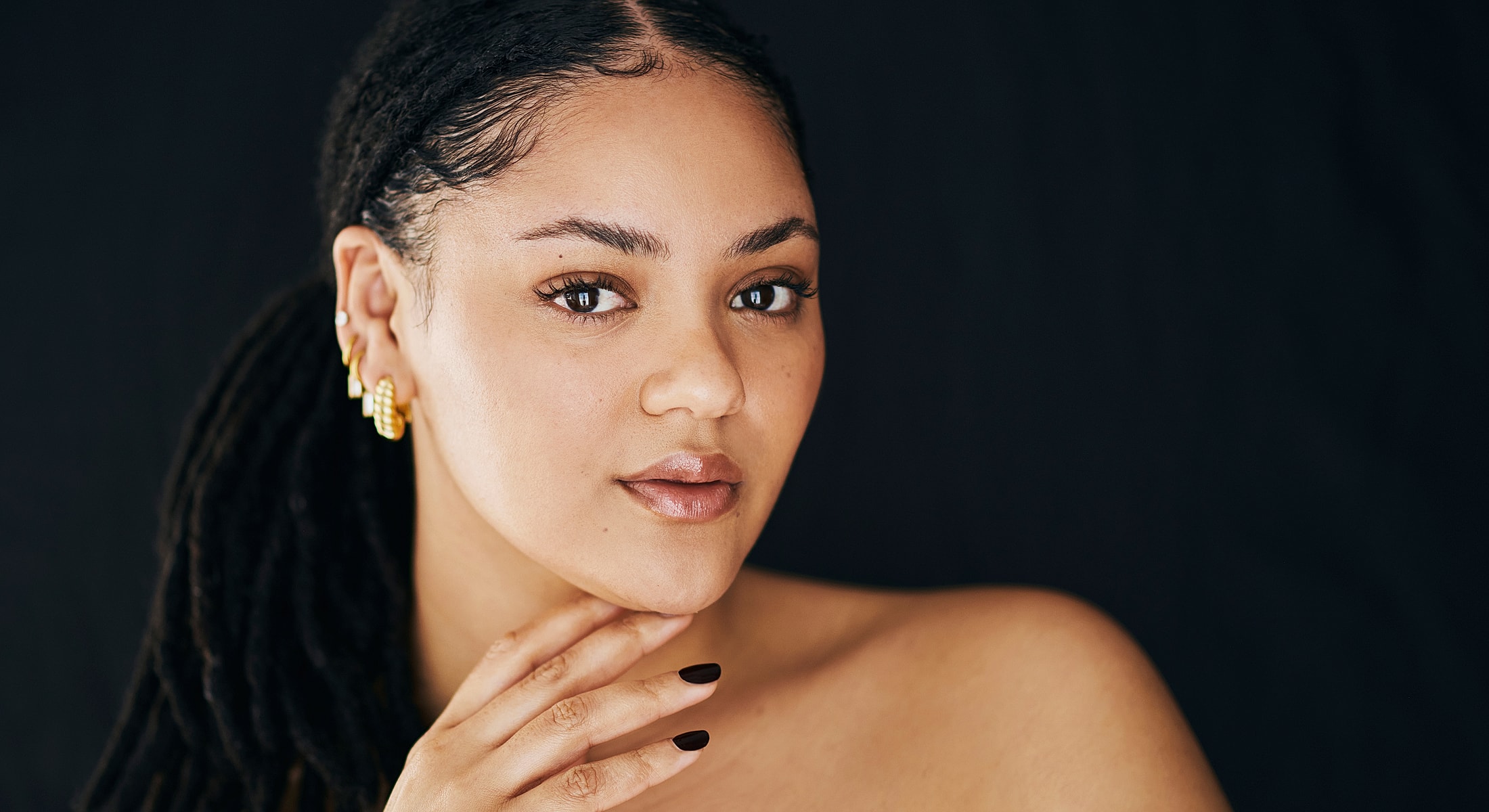 Smiling woman with blonde hair against white background.