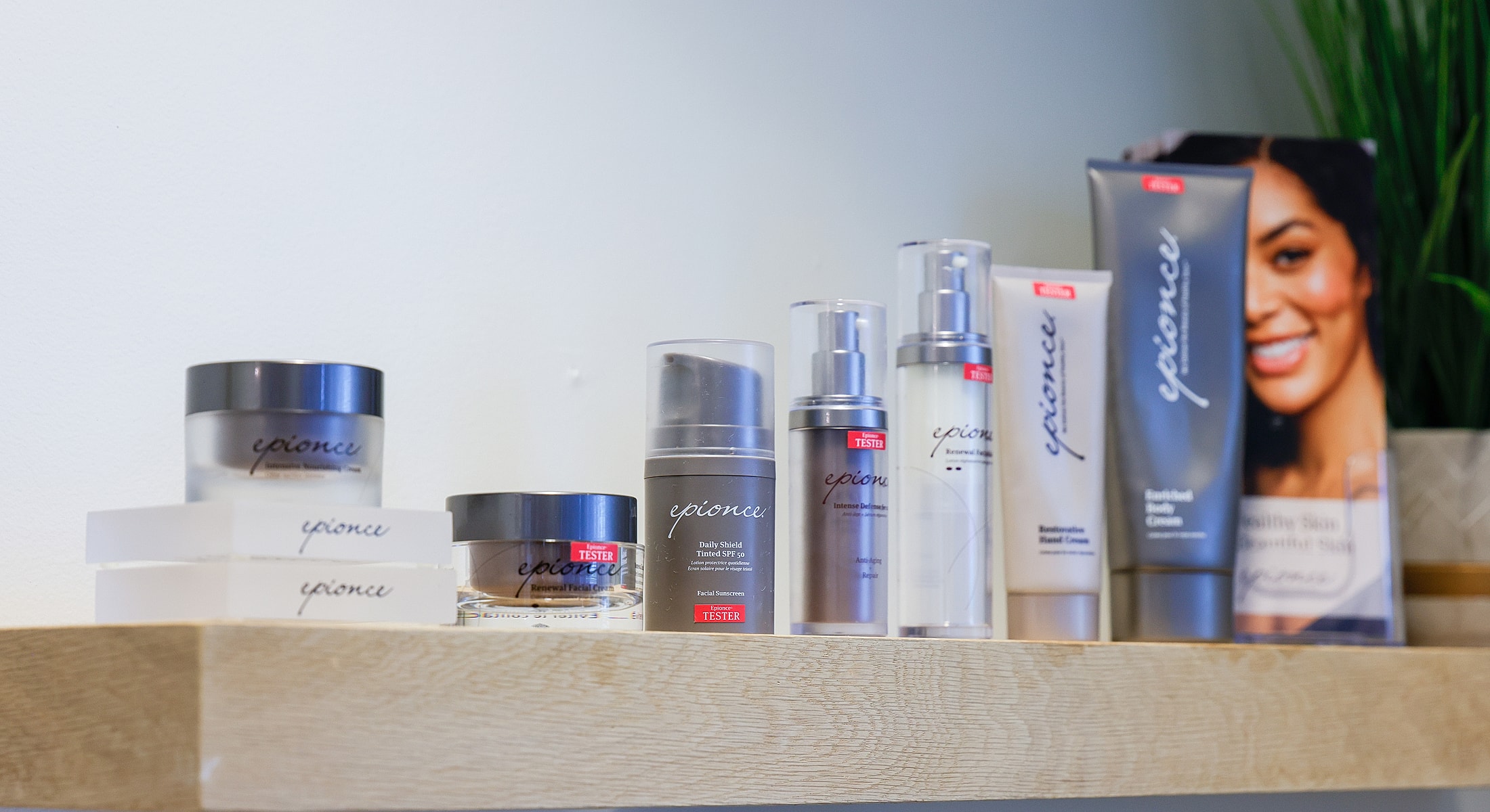 Assorted skincare products on a wooden shelf.