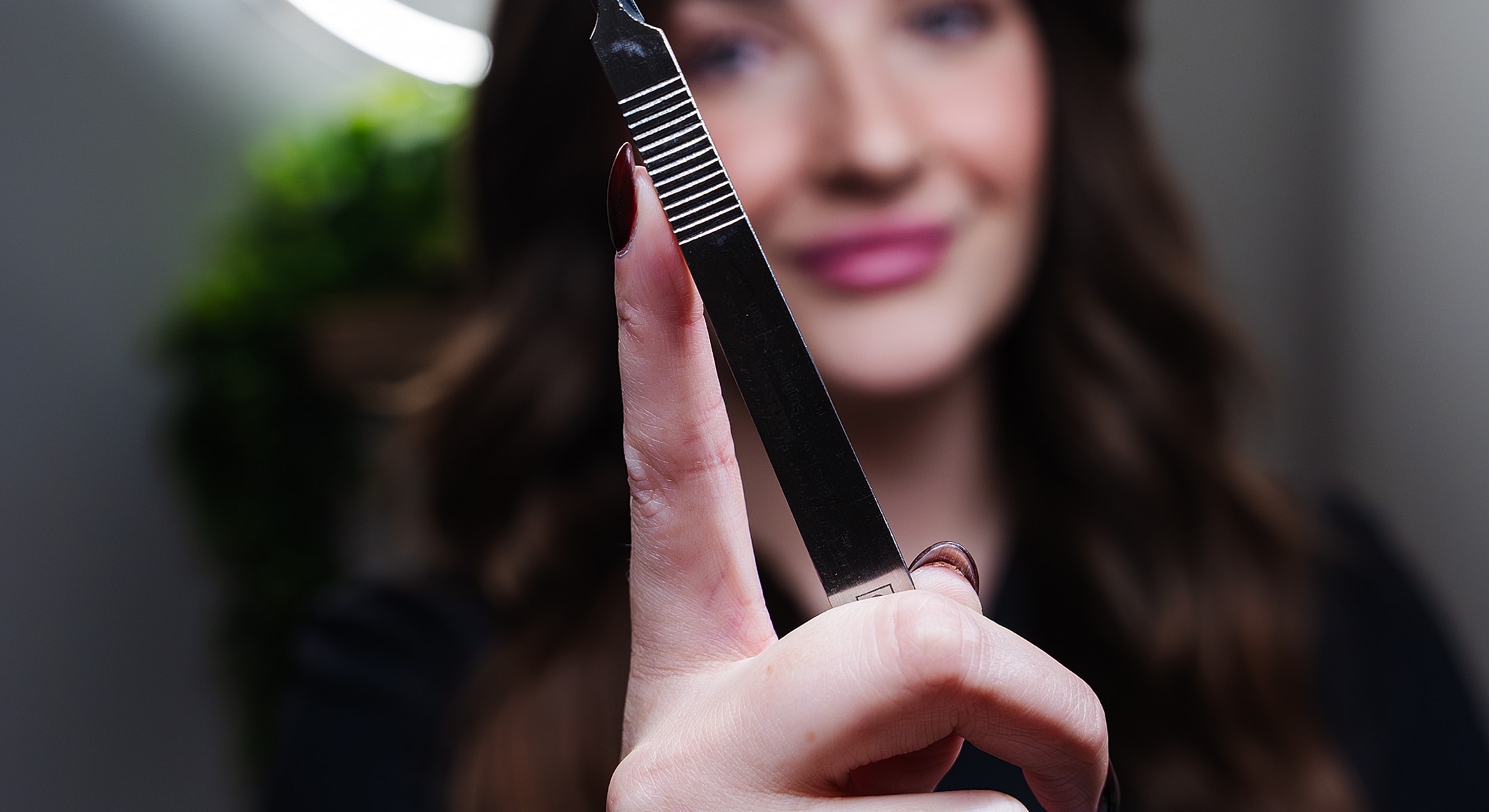 Woman holding a metal tool with beauty background.
