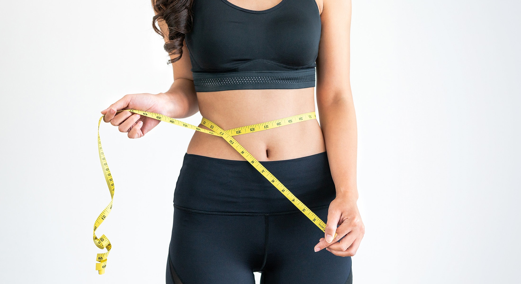 Measuring waist with a tape measure.