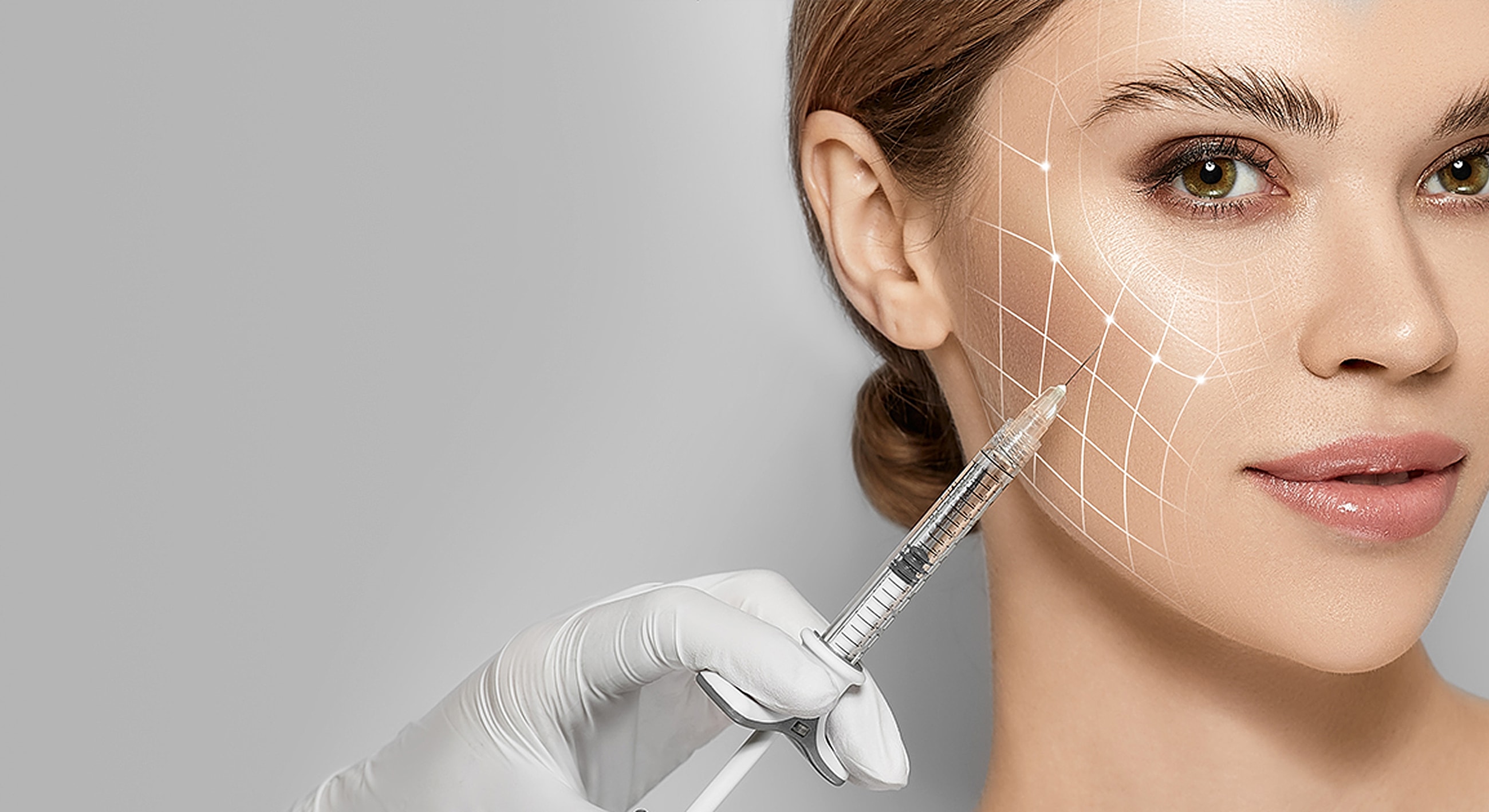 Woman receiving facial treatment with syringe.